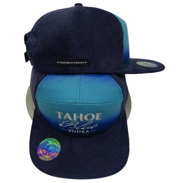 Tahoe Blue Vodka white logo embroidered on blue corduroy adjustable snapback hat. 